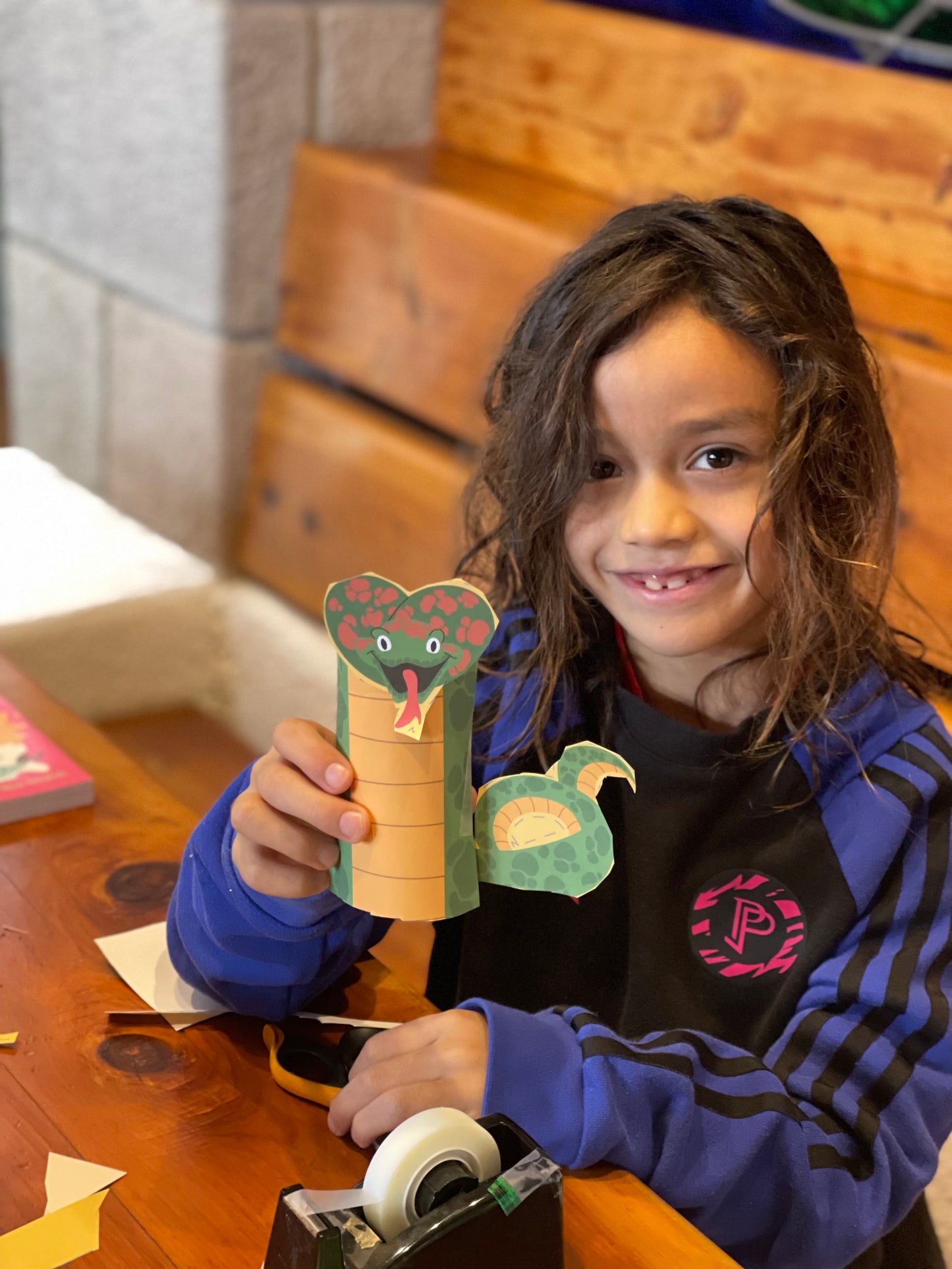 Child showing a craft they made with Mythical Creatures kids gift box